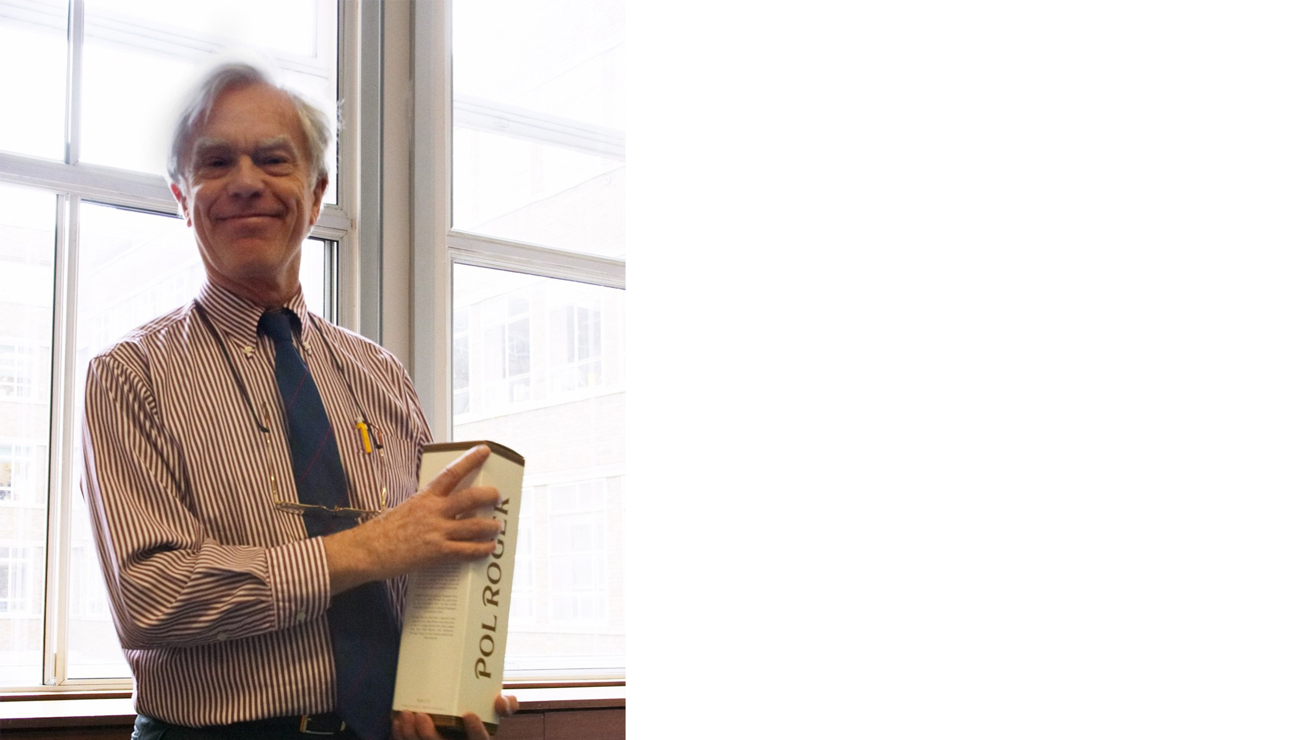 Professor John Bridgwater in a red and white vertical striped shirt holding a boxed bottle of Pol Roger champagne