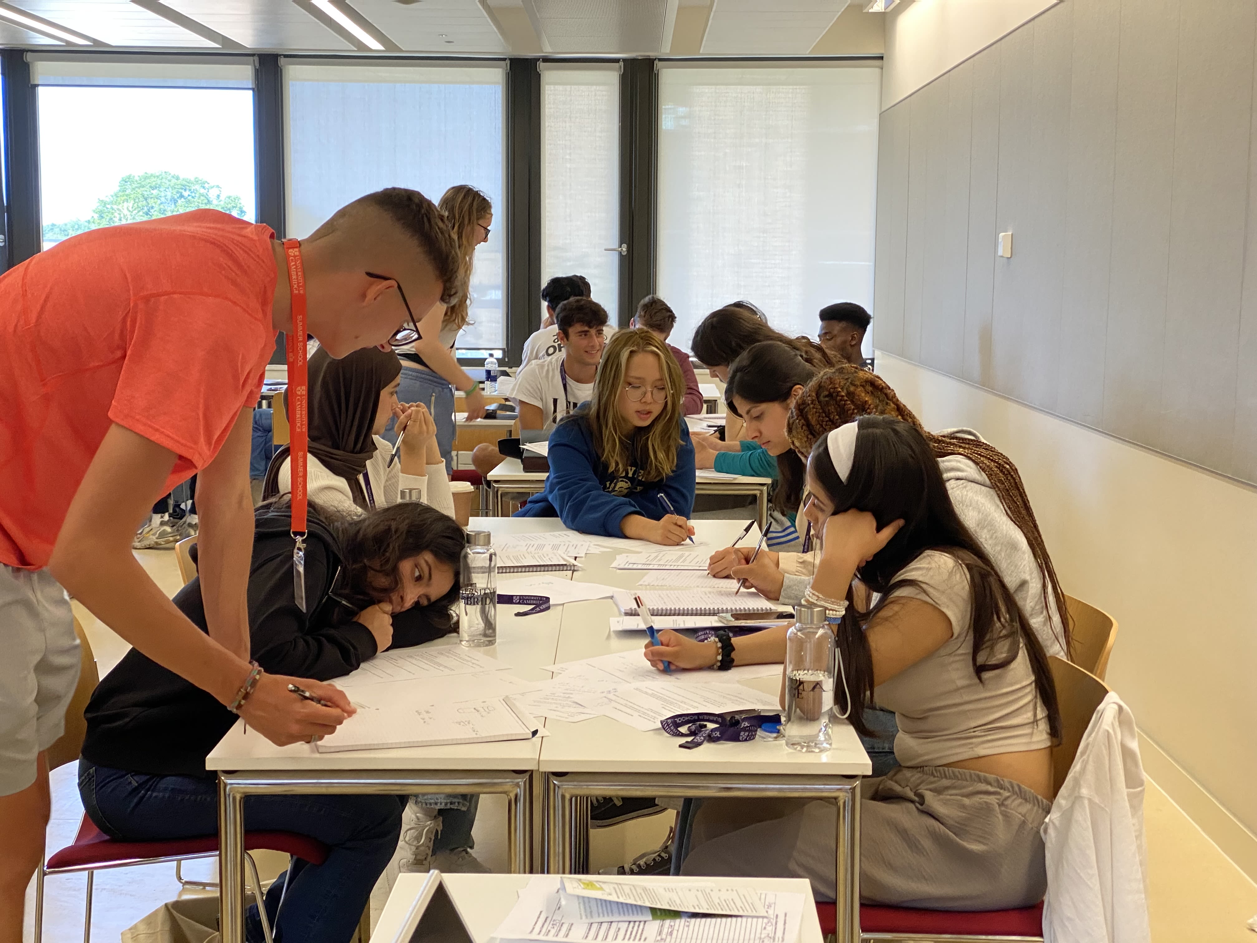 A-level student working together on a problem around a table