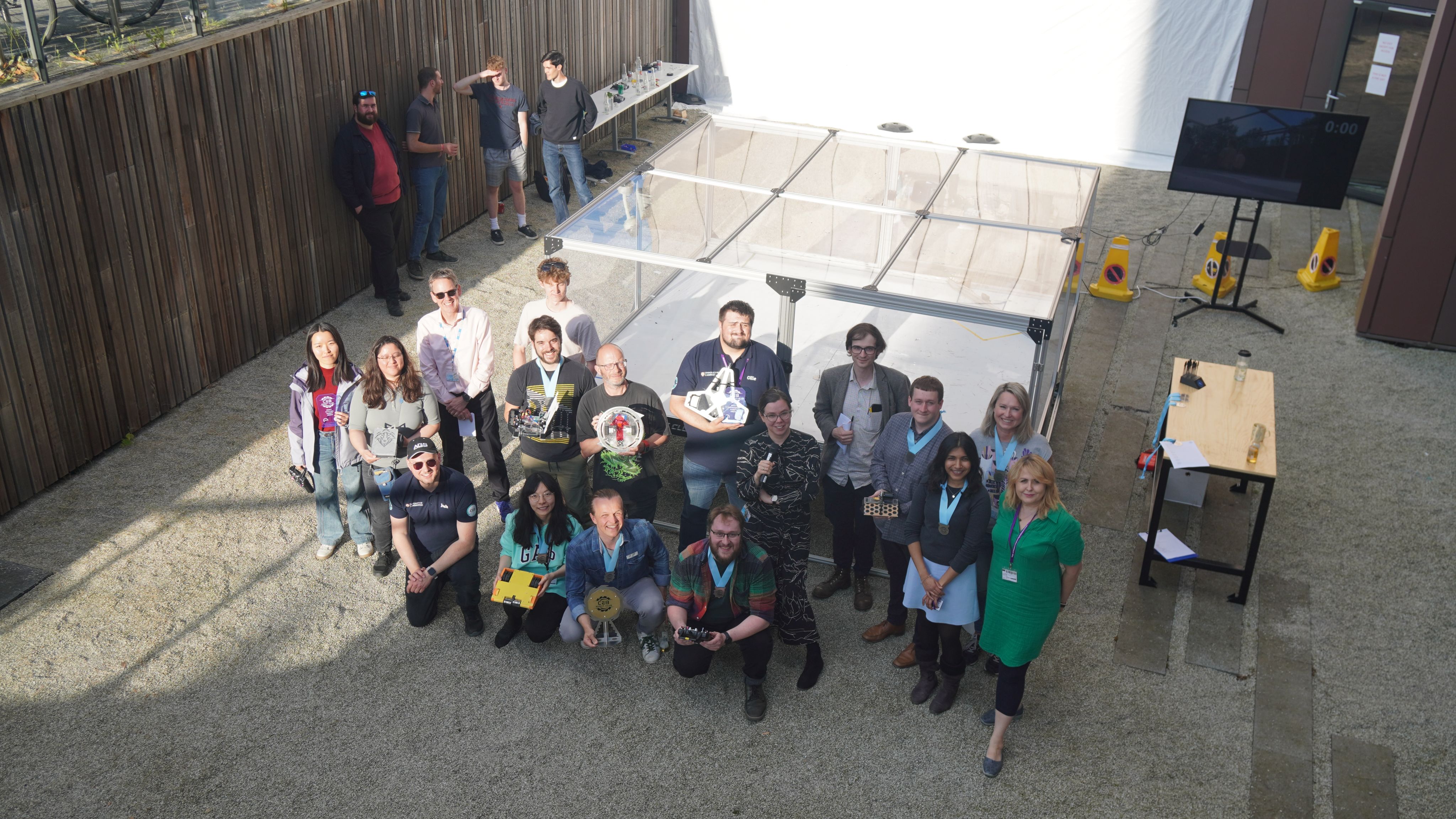 The winning teams (first, second and third) and the judges infront of the glass arena