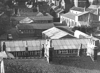 Black and white collection of temporary looking hut buildings