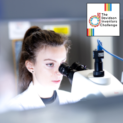 Young woman staring into a microscope