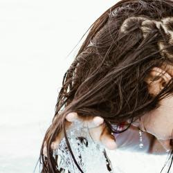 Woman washing hair in body of water