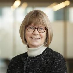 Head and shoulders of Lynn Gladden in professional setting smiling at camera