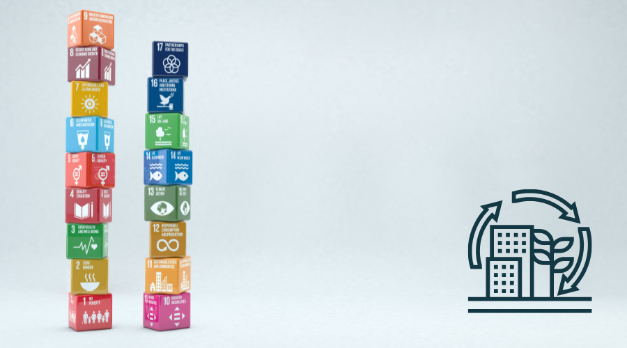 Two towers of wooden cubes showing the UN Sustainable Development Goals against a white background with a cartoon of skyscrapers, a plant and cyclical arrows to represent sustainability